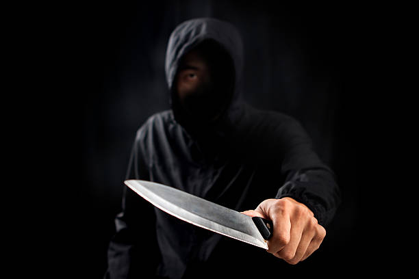 Dangerous criminal hold knife in hand.